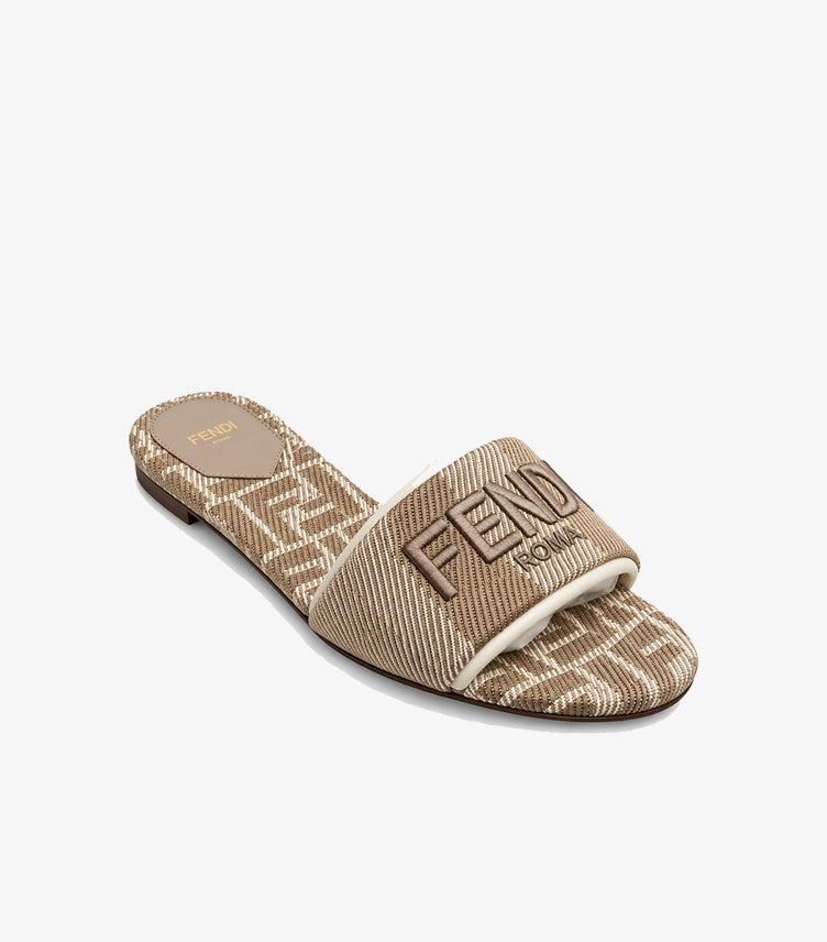 Angled view of Fendi women’s FF monogram flat sandal with wide embroidered Fendi Roma strap