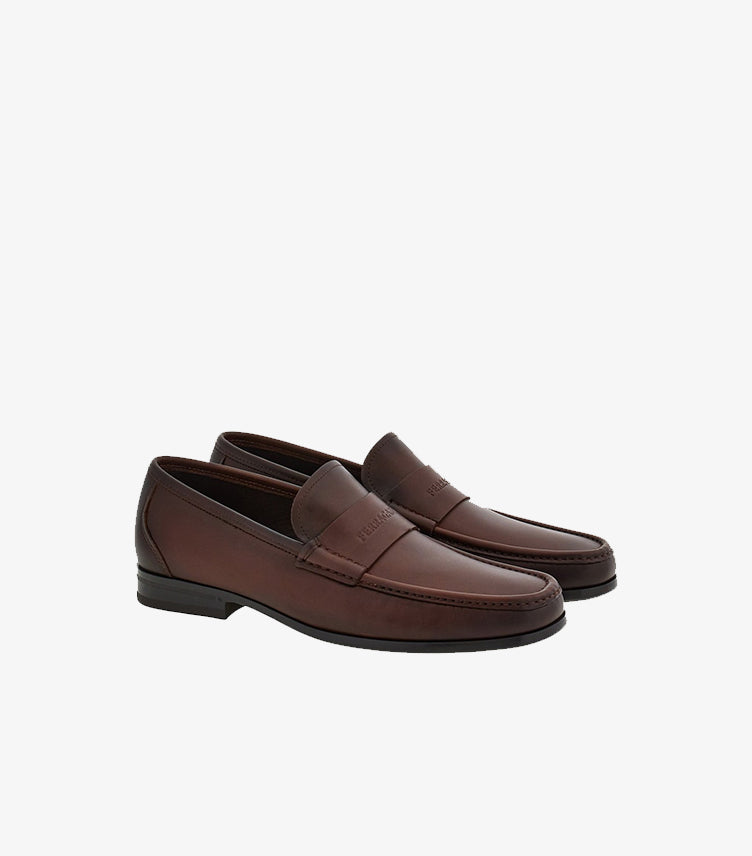Angled view of Ferragamo brown leather slip-on penny loafers for men