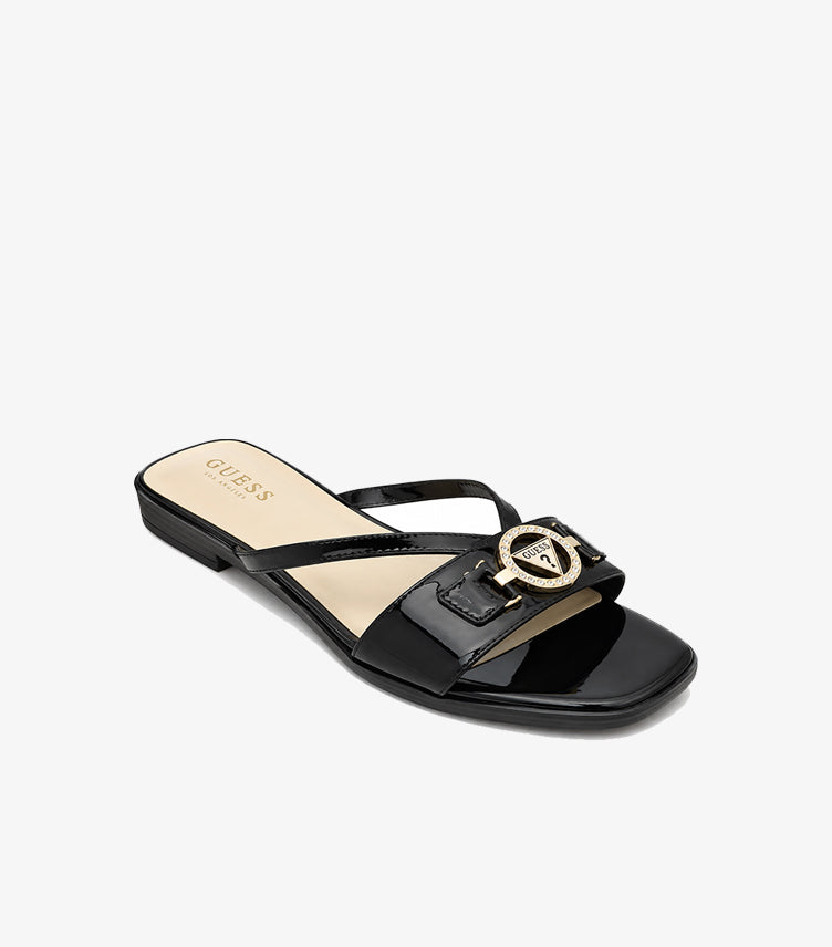 Angled view of Guess black patent open-toe sandal with embellished triangle logo and beige footbed