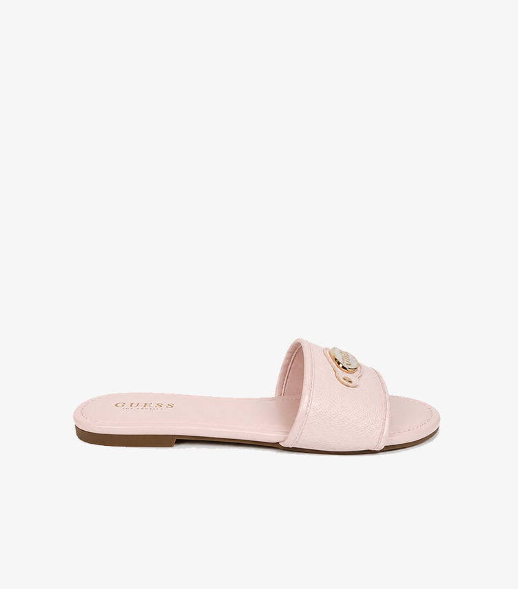 GUESS Los Angeles pink pebbled leather flat slide sandal side profile showing wide strap gold logo hardware and brown outsole