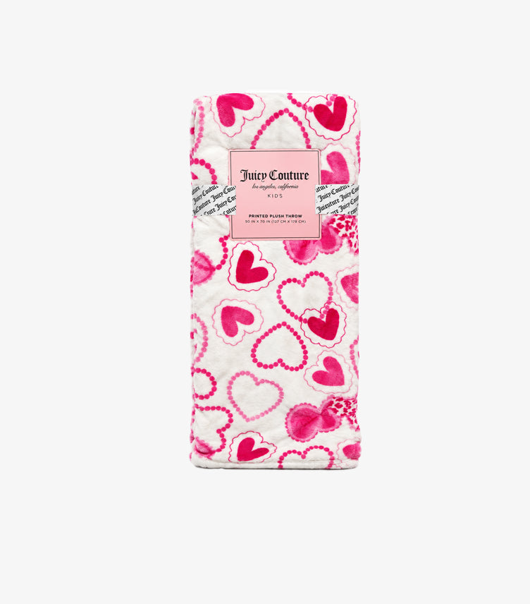 Folded Juicy Couture pink heart print plush throw blanket in branded packaging showing 50 x 70 inch dimensions