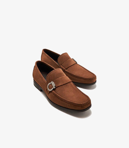 Angled pair of Ferragamo brown suede loafers featuring silver-tone Gancini hardware and moc-toe stitching