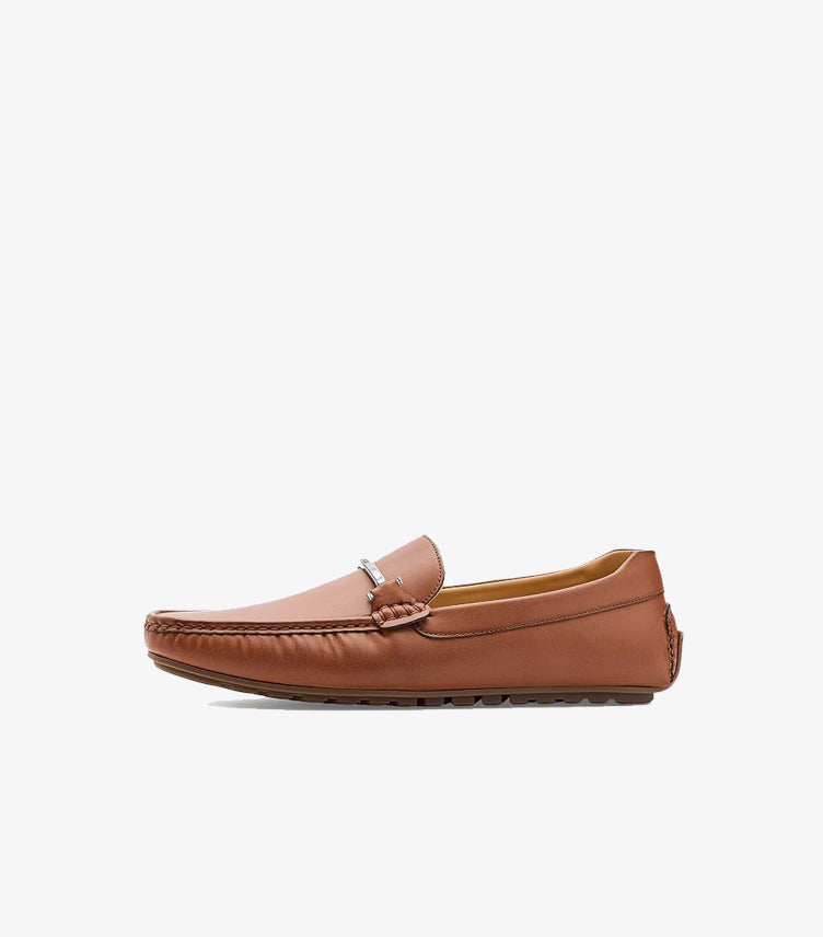 Side view of Tommy Hilfiger brown slip-on driving loafer with metal vamp detail and rubber-grip sole