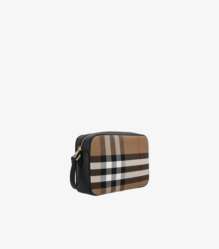 Angled view of Burberry Vintage Check crossbody camera bag showing black side panels and gold-tone zip hardware