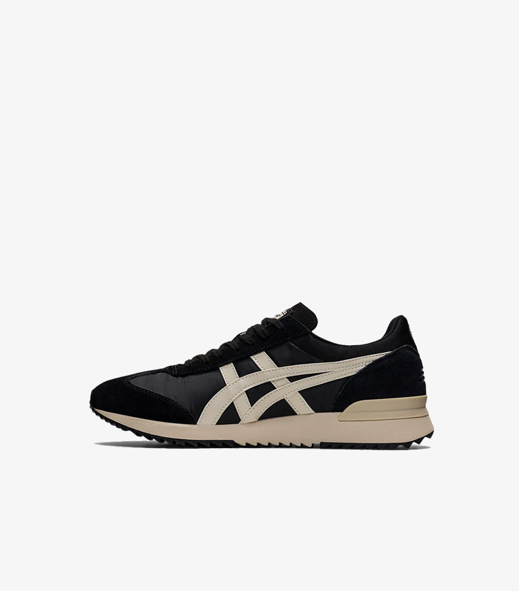 Inner side view of Onitsuka Tiger black retro sneakers with cream stripe detailing