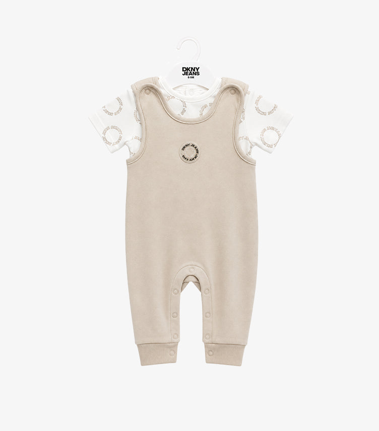 Front view of DKNY Jeans baby boys’ beige full-length dungaree and white circular logo-print T-shirt set.