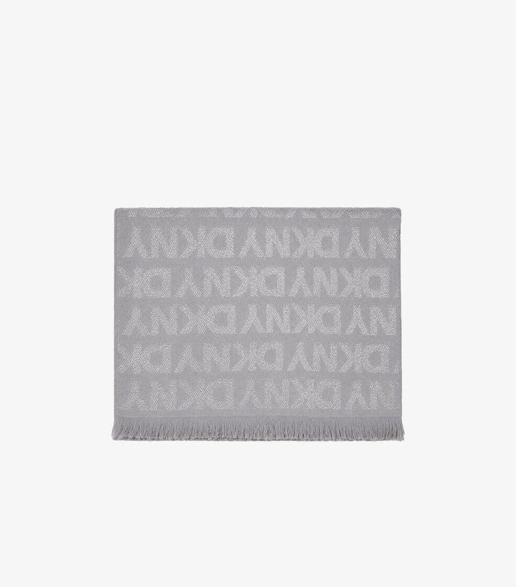 Folded DKNY designer scarf with signature monogram print and elegant fringe trim.