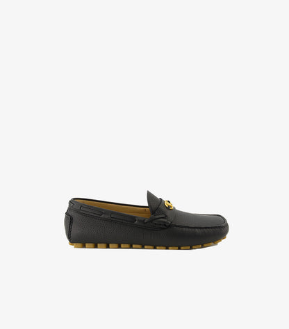 Valentino Garavani men's black leather driving loafer side profile with tan rubber studded sole