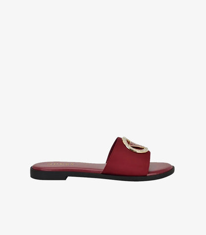 Side view of Guess burgundy open-toe sandal with wide strap, gold hardware and black flat sole