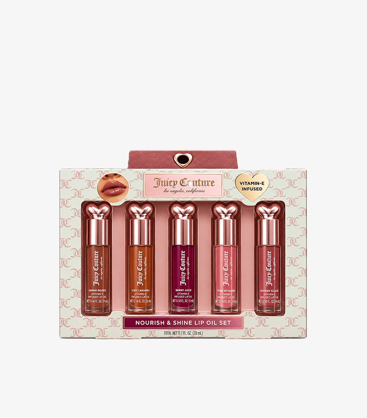 Juicy Couture Nourish & Shine Vitamin E Lip Oil Gift Set featuring five tinted lip oils in cream and pink packaging.