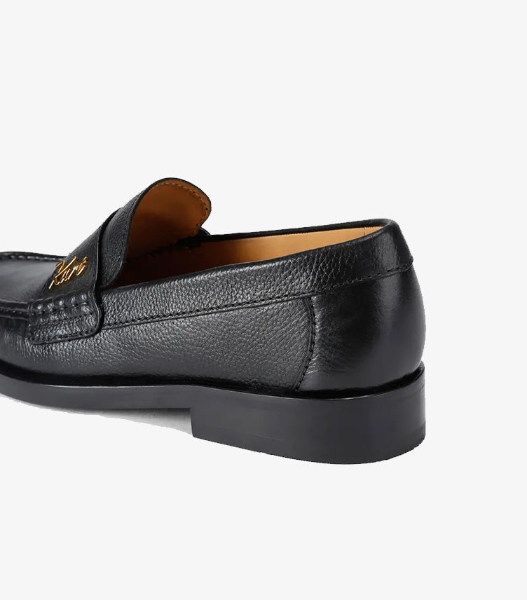 Side and heel view of Kurt Geiger London black leather loafers with durable rubber outsole.