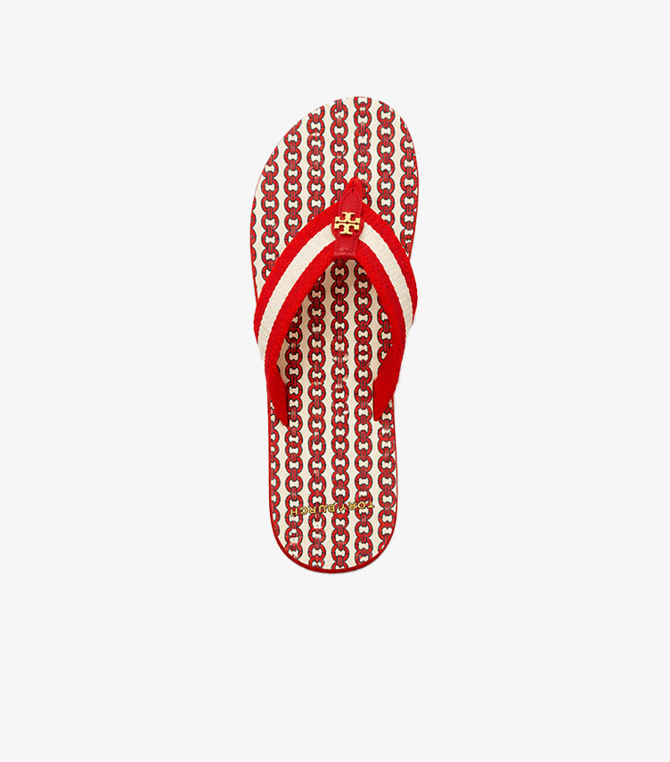 Top view of Tory Burch red, ivory and blue printed flip-flop with signature gold logo