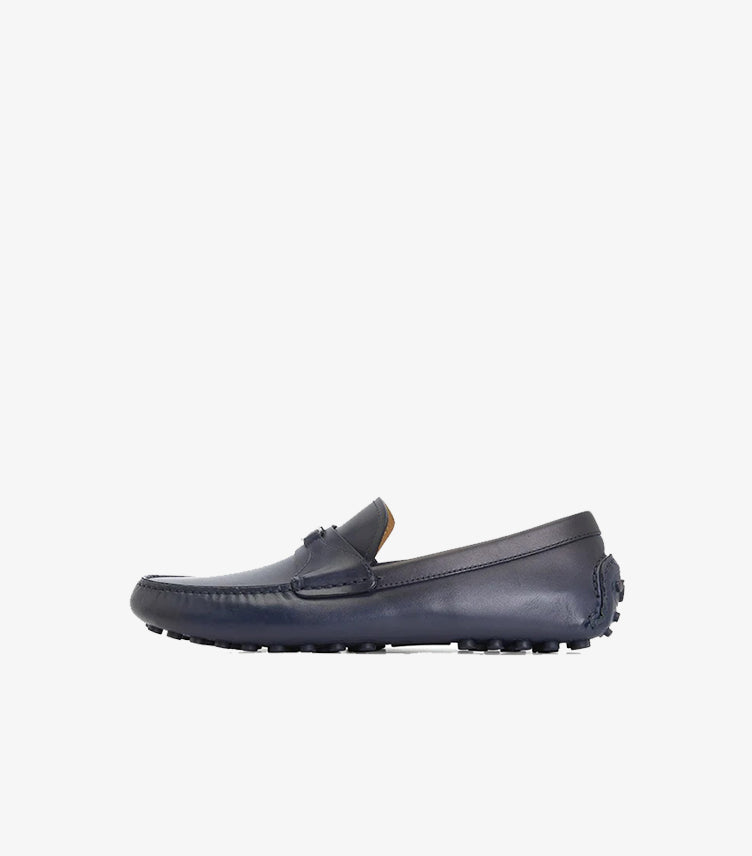 Side view of Ferragamo navy leather driving loafer with rubber pebble sole