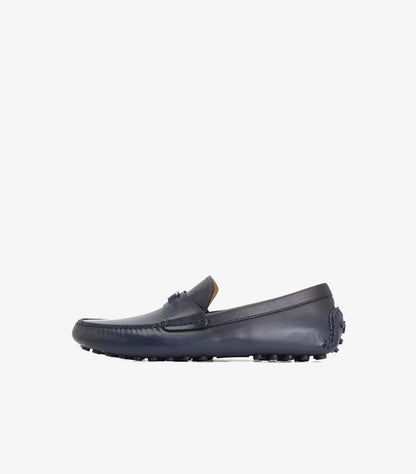 Side view of Ferragamo navy leather driving loafer with rubber pebble sole