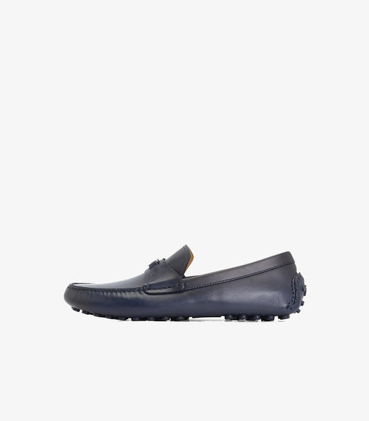 Side view of Ferragamo navy leather driving loafer with rubber pebble sole