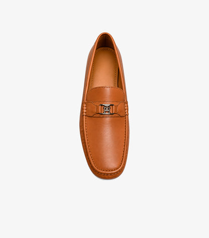 Top view of Tommy Hilfiger men’s tan driving loafer with polished TH monogram hardware and moccasin stitching