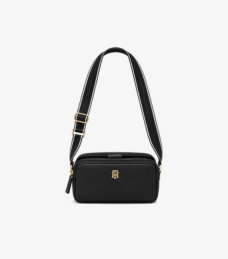 Front view of Tommy Hilfiger crossbody camera bag with gold-tone TH monogram and branded webbing strap