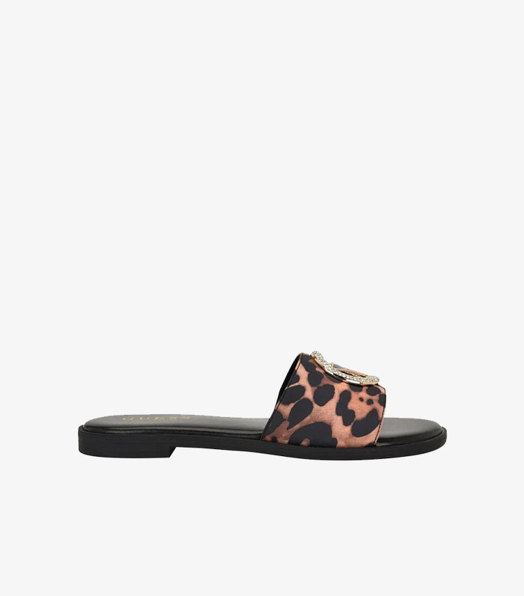 Side view of Guess women’s leopard-print sandal with wide logo strap and slim black sole