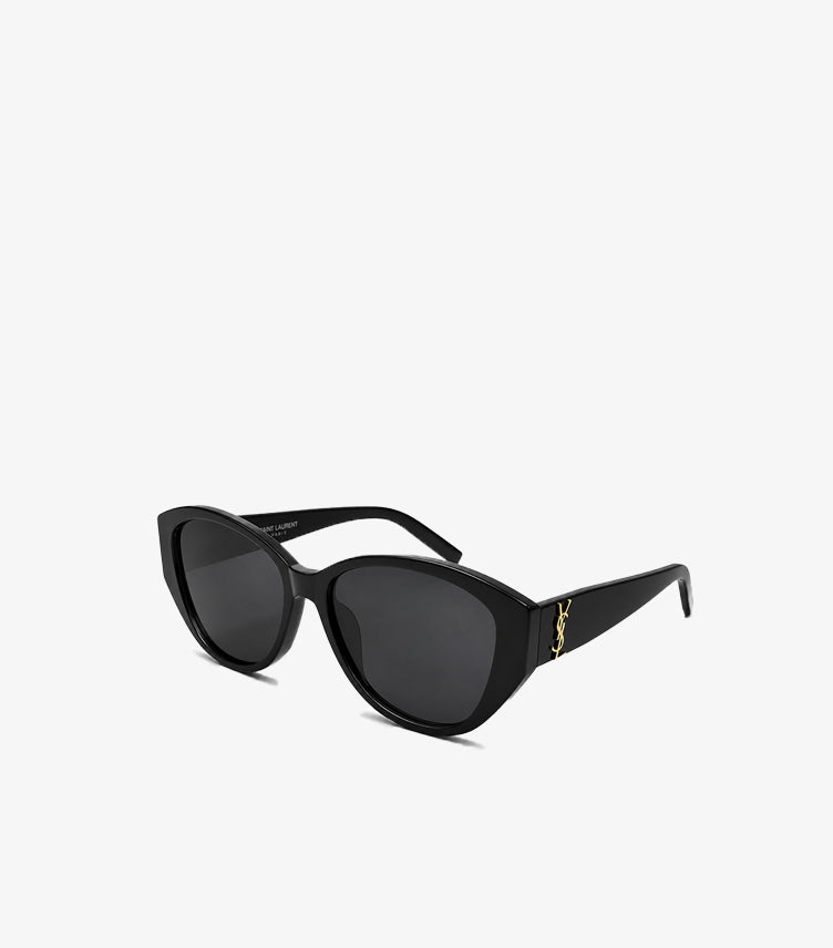 Angled view of Saint Laurent black cat-eye sunglasses featuring wide arms and gold YSL temple logo