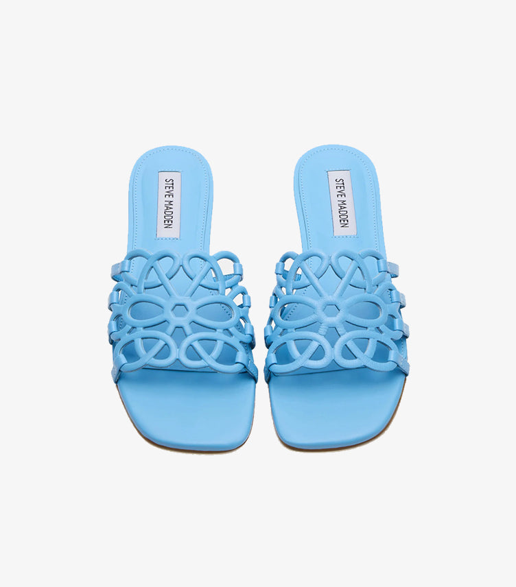 Side view of Steve Madden women’s sky-blue flat slide sandal with floral cutout strap