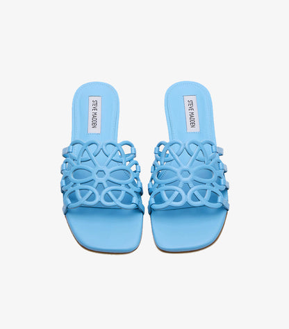 Side view of Steve Madden women’s sky-blue flat slide sandal with floral cutout strap