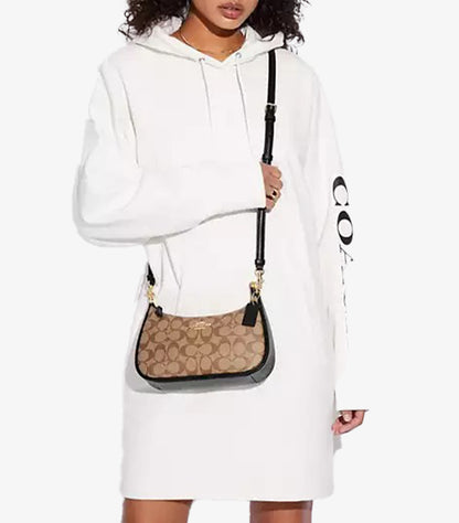 Model wearing Coach Teri Signature canvas bag as crossbody with 22.75 inch strap drop