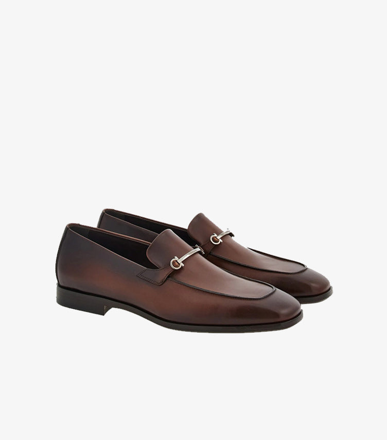 Ferragamo men's brown burnished leather Gancini Bit loafers angled pair view showing silver hardware and antiqued finish