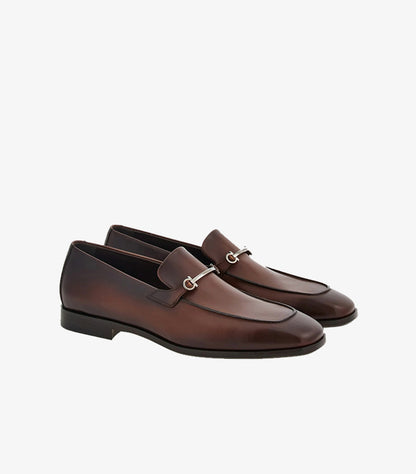 Ferragamo men's brown burnished leather Gancini Bit loafers angled pair view showing silver hardware and antiqued finish