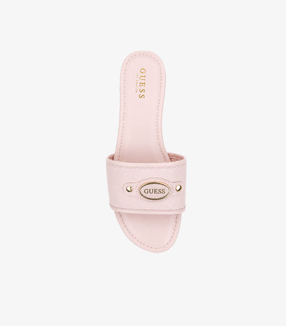 GUESS pink wide-strap flat slides top-down view showing oval GUESS gold logo plaque and GUESS LOS ANGELES branded insole